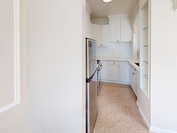 Kitchen with cabinets and refrigerator