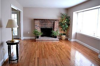 Sunny living room with brick fireplace