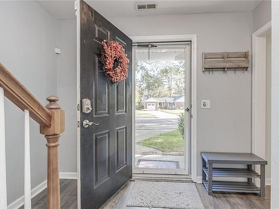 Bright entryway onto updated luxury vinyl plank flooring.