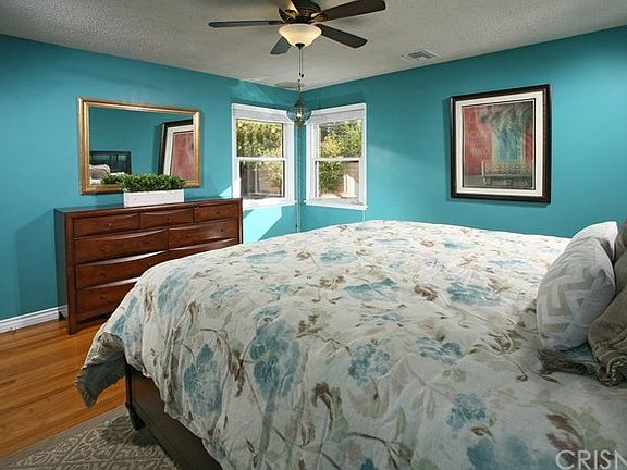 The large master bedroom is drenched in natural li