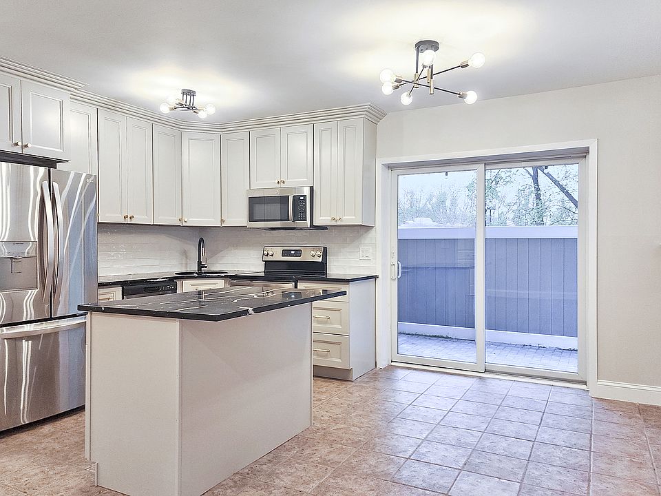 Brand-new kitchen with new stainless steel appliances, large island and quartz counter tops. Dining area features a sliding door to the private patio.