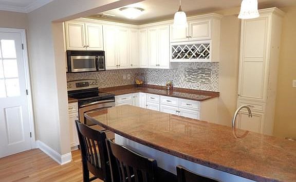 Travertine marble back splash, custom cabinets, granite counters.