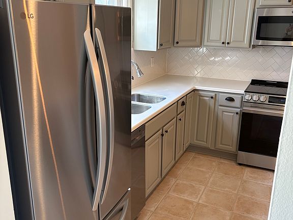 Kitchen view from entry - shows sink window view to front of house