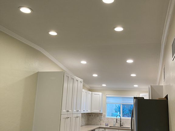 Kitchen with high-end LG refrigerator and large pantry cabinets