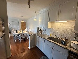 Newer white kitchen with S.S. dishwasher, ref, microwave and range/oven.