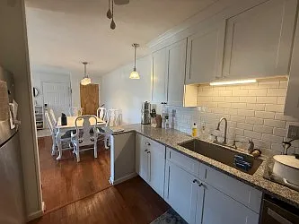 Newer white kitchen with S.S. dishwasher, ref, microwave and range/oven.