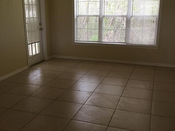 Living area with French door to balcony. Private , wooded view.