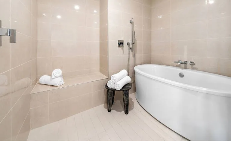 Sky Residence C primary washroom featuring a luxurious tub and refined design details.