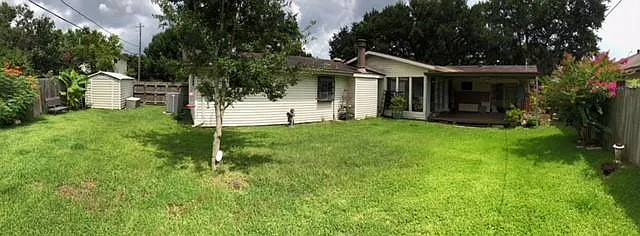 Back of home. Covered patio. Includes storage shed.
