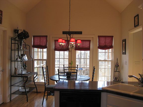 Kitchen opens up to breakfast area & screened porch