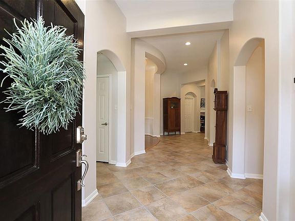 ENTRY - As you enter the home, you notice the beautiful arched doorways, recessed lighting, and updated tile laid on the diagonal. Wide entry hall.