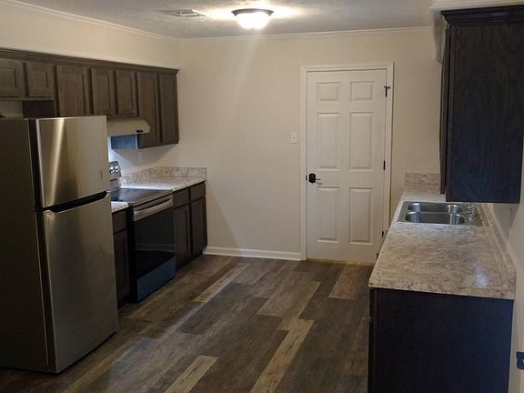 Shaker style cabinets and stainless steel appliances.