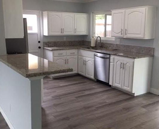 Kitchen with recessed lighting, new flooring and appliances. Samsung is provide the microwave in mid-July. Eating nook and patio access is to the right of the kitchen cabinet.