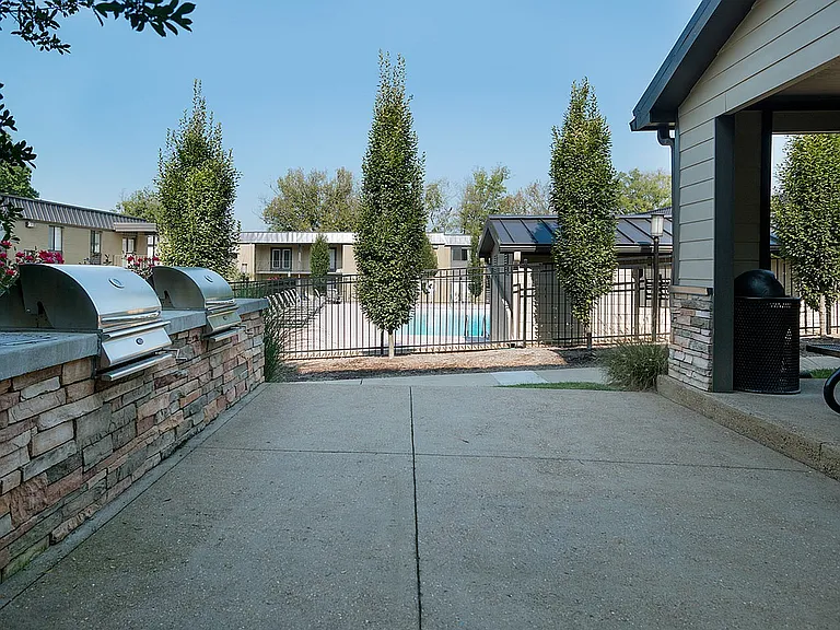 Relax in style with a well-equipped patio and a serene poolside view.