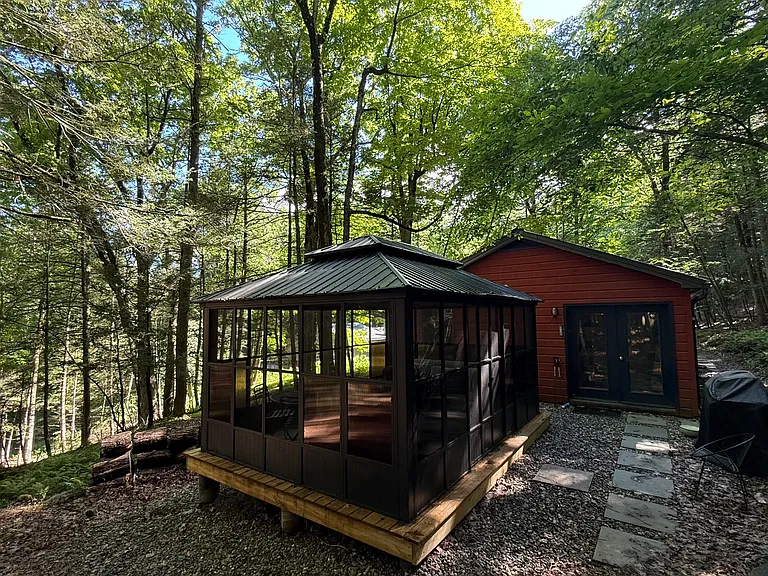 Screened porch, bluestone path, and grill to the right