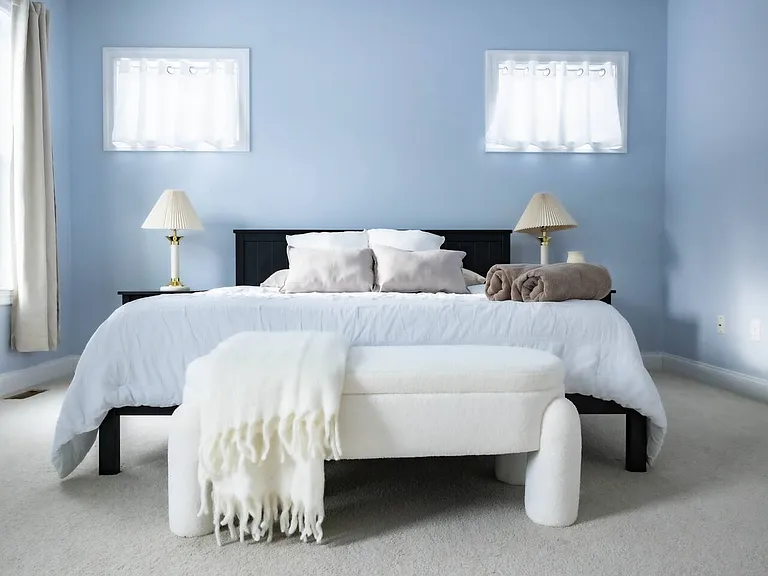 Downstairs Master Bedroom Shown with a King Mattress. Includes a Walk-In Closet and Ensuite Bathroom