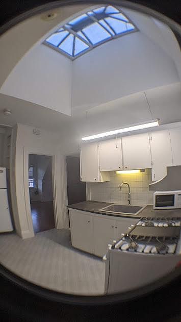 Kitchen view, large sky window, new range, new sink and faucet installed.