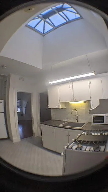Kitchen view, large sky window, new range, new sink and faucet installed.