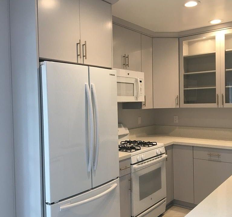 Kitchen features a large refrigerator, stove, microwave, dishwasher and plenty of storage space.
