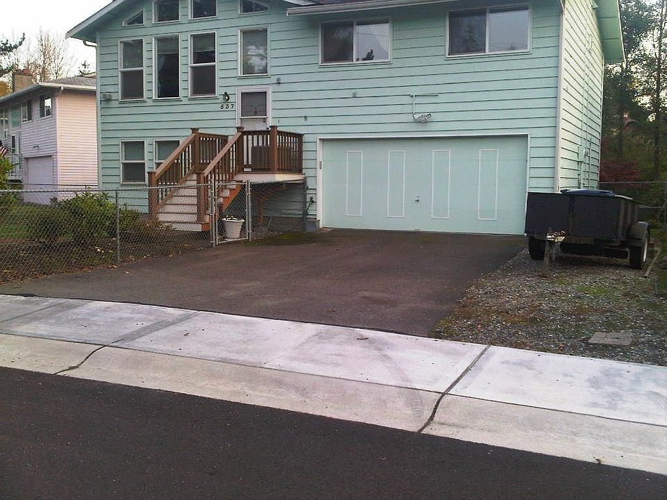 The front of the house with the trailer/RV parking on the right.