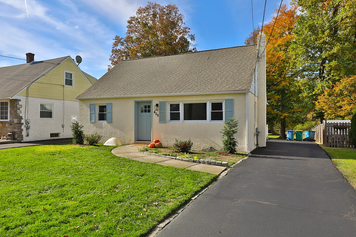 Front of the house and driveway. You can park up to three cars in the driveway - 409 Brookside Ave