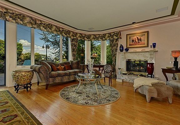 The gracious living room features hardwood floors, a gas firepla
