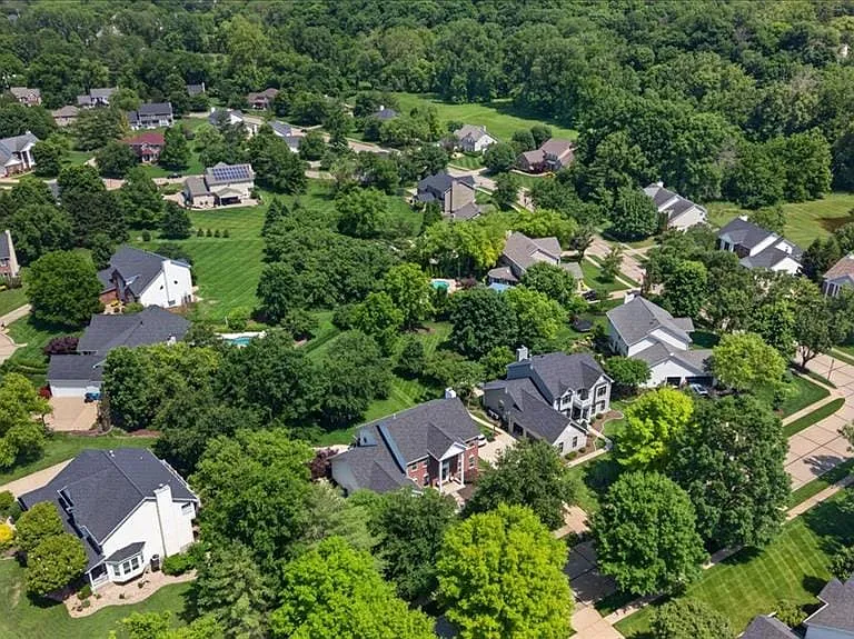 Residential neighborhood featuring mature trees and manicured lawns