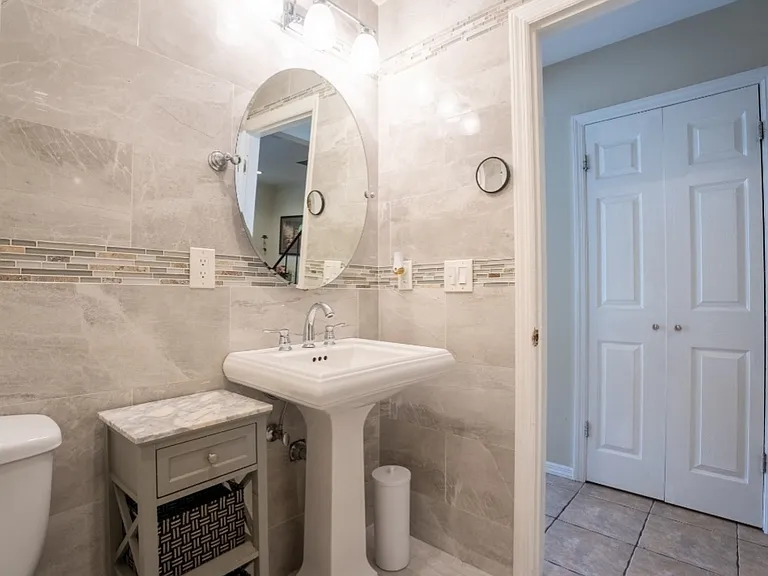 across from the bathroom, double door walking-in pantry with coat area