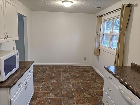 Area to eat in kitchen. 2 large windows in the kitchen