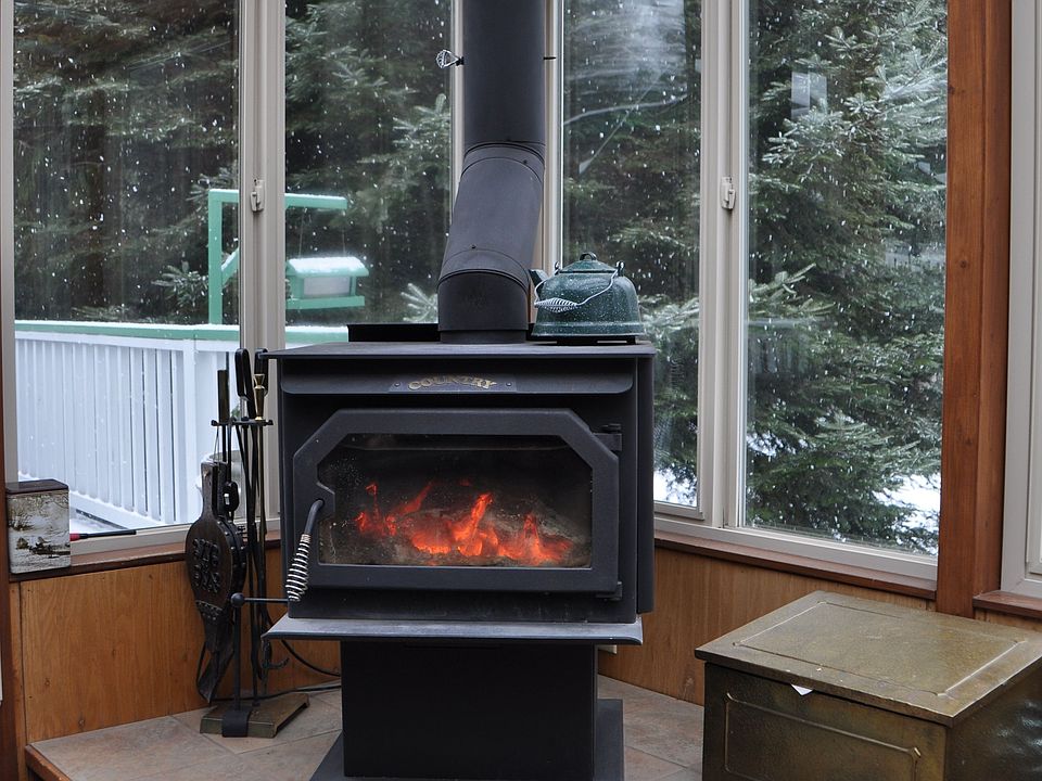 wood fireplace in sunroom