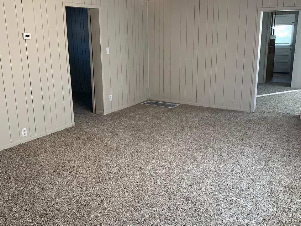 Living Room-That is not a working floor furnace. There is central heat.