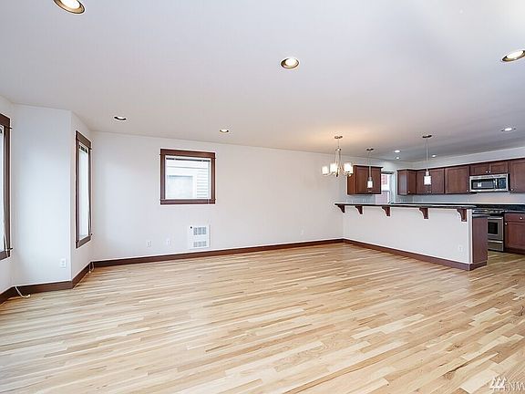 Gas fireplace in large living room with balcony/deck