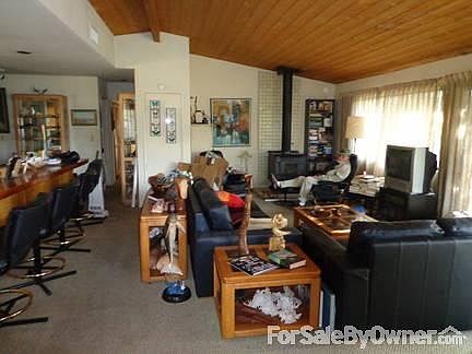 Living Room
						:
						Living room w/ cast iron stove box-heats whole house. Whole west side is glass