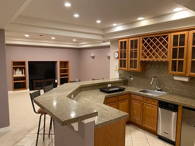 Kitchenette with cooktop, mini-frog, shared freezer space in garage.