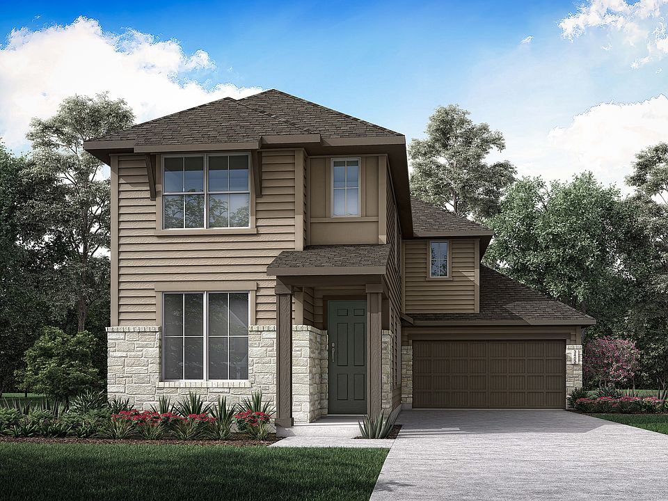 A two-story wooden house with a garage, surrounded by lush greenery and a clear blue sky with fluffy