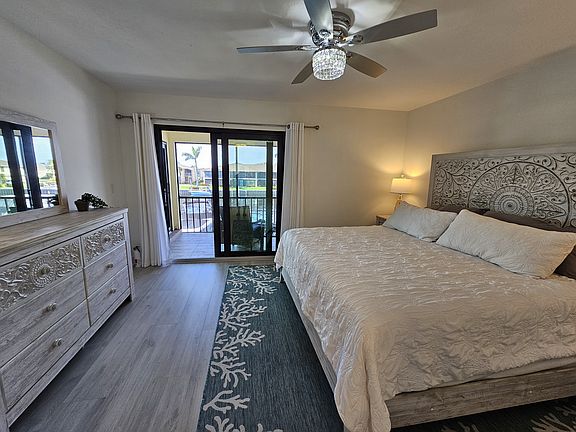 Master bedroom has a beautiful king sized bed overlooking the water.