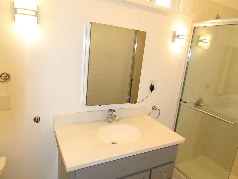 Bathroom #1 - Corian countertop bath cabinet, fan, exterior window, walk in shower