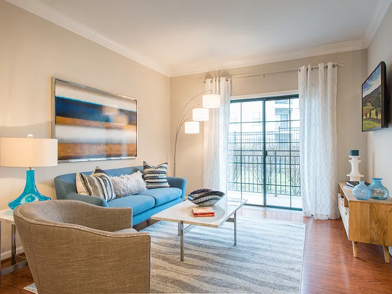 Spacious living areas with hardwood flooring at The Cosmopolitan at Lorton Station, Lorton