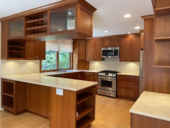 Kitchen, with bar-height peninsula, overhead rack
