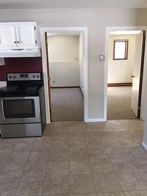View of bedrooms from living room. Carpet in bedroom on the right now has laminate flooring.