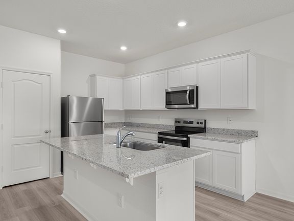 Granite countertops fill the kitchen