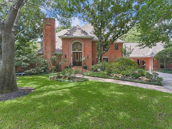 The beautifully landscaped lawn greets you as you approach this stately home.