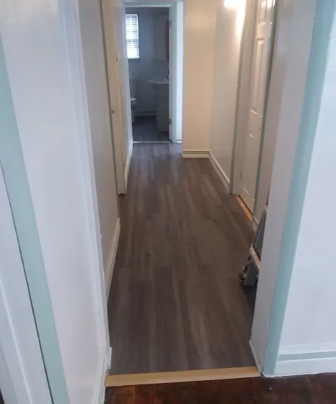 hallway from living room facing bathroom at end of the hall. north bedrooms to the right, south bedroom to the left.