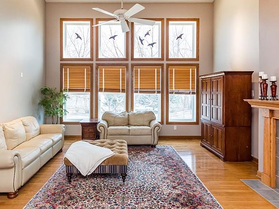 Main level two story family room.  Lots of natural light fills this room with the wall of windows.   Two-sided gas fireplace between the kitchen hearth room and the family room.