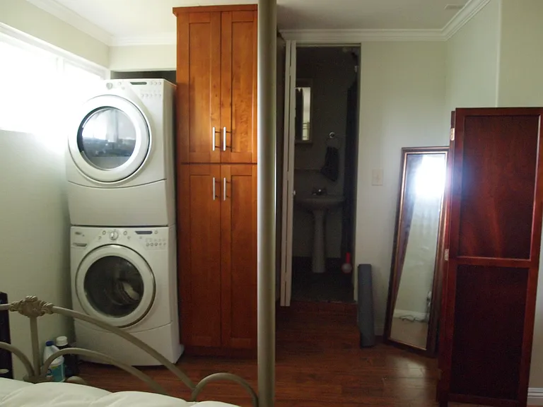 Washer and dryer and bathroom entry door.