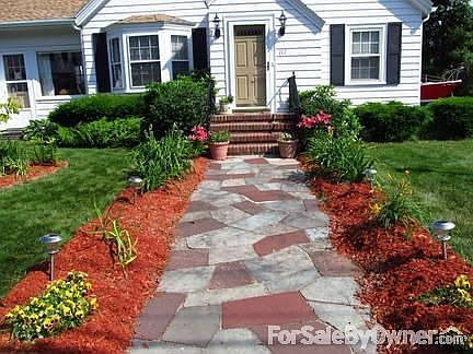 Front Entrance : Flagstone path flanked by three-season perennial flowerbeds; brick stairs