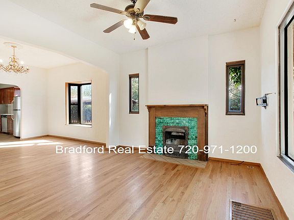 Front living room with decorative fireplace looking into dining room