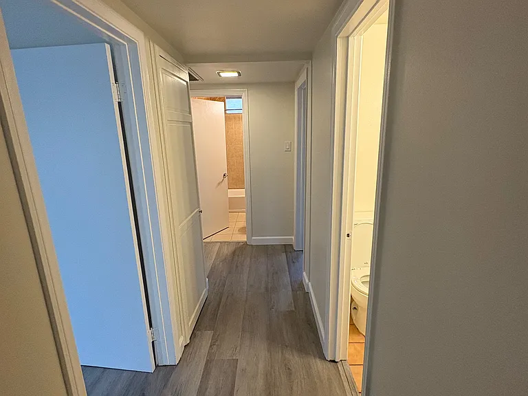 Moving down central hallway. First door on the left is the Master Bedroom, first door on the right is 2nd. of 2 bathrooms. Straight ahead the larger bathroom. Not visible at the end of the hall, doorways to other 2 bedrooms