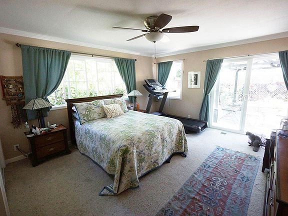 Master Bedroom with sliding glass door to deck and pergola.