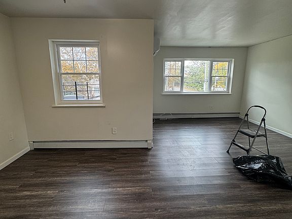 Spacious living area with modern flooring and an open layout that easily fits a full living room setup plus dining space.
